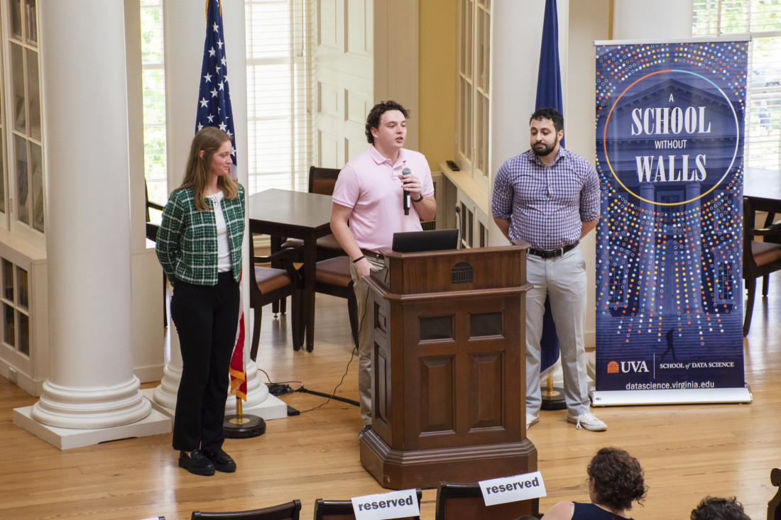 UVA Data Science MSDS students give their presentation at a podium in the Dome Room of the Rotunda
