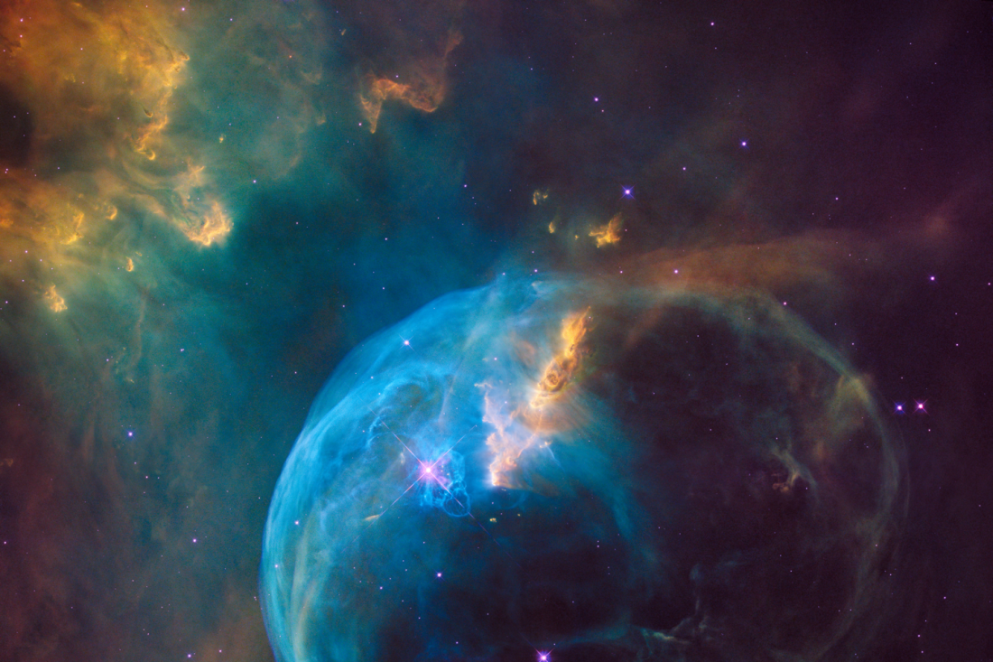 A vibrant nebula with swirling blue and orange clouds, illuminated by bright stars against a dark space backdrop.